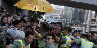 Les forces de l’ordre écartent les manifestants après la condamnation des leaders du « mouvement des parapluies », à Hongkong le 17 août.