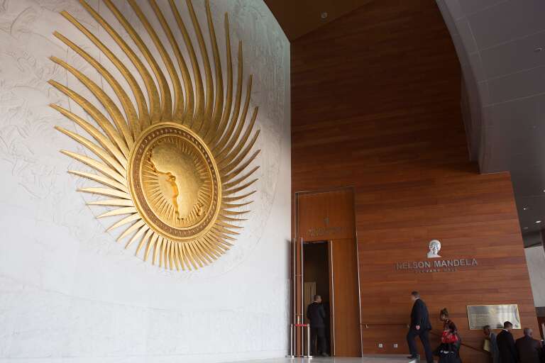 Delegates attending the 28th African Union (AU) Heads of State Summit walk into the main plenary hall at the AU hearquarters prior to the opening ceremony on January 30, 2017 in Addis Ababa. African Union leaders meet for a summit that has exposed regional divisions as they mull whether to allow Morocco to rejoin the bloc, and vote for a new chairperson. The two-day summit in Ethiopia comes after several shake-ups on the international stage: the election of US President Donald Trump and a new head of the UN, Antonio Guterres, who will address the opening of the assembly. / AFP PHOTO / Zacharias ABUBEKER