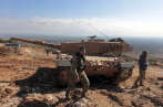 Pro-Turkey Syrian fighters and Turkish troops secure the Bursayah hill, which separates the Kurdish-held enclave of Afrin from the Turkey-controlled town of Azaz, Syria, Sunday, Jan. 28, 2018. Turkish troops and allied Syrian fighters captured the strategic hill in northwestern Syria after intense fighting on Sunday as their offensive to root out Kurdish fighters enters its second week, Turkey's military and Syrian war monitor reported. (AP Photo)