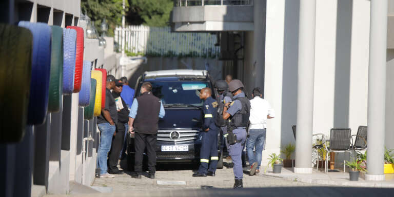 South African policemen outside the home of the Gupta family in Johannesburg on 14 February.