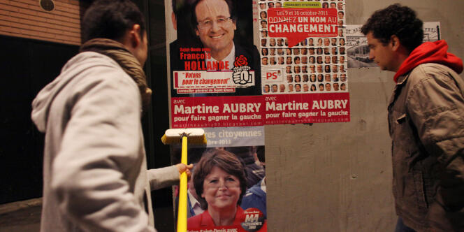 A Saint-Denis, de jeunes militants socialistes collent des affiches de Martine Aubry pour la primaire, lundi 19 septembre.