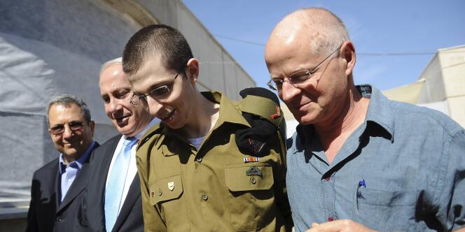 Gilad Shalit au côté de son père, Noam Shalit (à dr.), et du premier ministre israélien, Benyamin Nétanyahou, le 18 octobre 2011 à son arrivée en Israël.