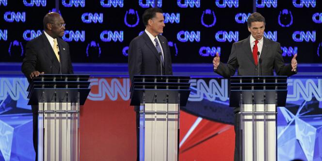 Herman Cain (à gauche), candidat républicain apprécié des Américains, a été la cible de ses concurrents Mitt Romney et Rick Perry.