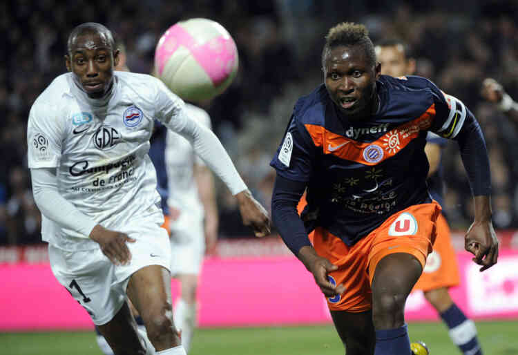 Caen's French forward Livio Nabab (L) vies with Montpellier's defender Mapou Yanga-Mbiwa from Central Africa (R) during the French L1 football match Montpellier vs.Caen on March 11, 2012 at the Stade de la Mosson in Montpellier, southern France.  AFP PHOTO / ANNE-CHRISTINE POUJOULAT