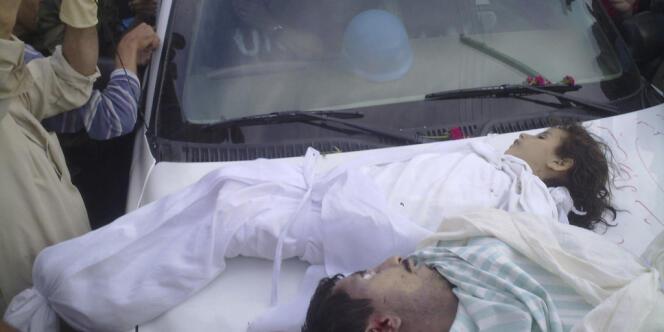Image diffusée par l’opposition syrienne montrant les corps d’une enfant et d’un homme disposés sur le capot d’une voiture des observateurs de l’ONU, à Houla, le 26 mai.
