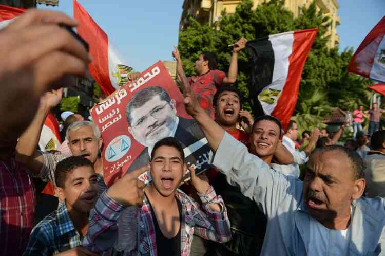 Egyptians celebrate on June 24, 2012, in Cairo’s Tahrir Square the victory of Muslim Brotherhood member Mohamed Morsi who was declared the first president of Egypt since a popular uprising ousted Hosni Mubarak, capping a tumultuous and divisive military-led transition.  AFP PHOTO / KHALED DESOUKI