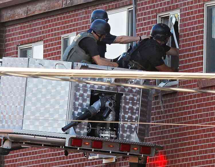 Police use a video camera to look inside an apartment  where the suspect in a shooting at a movie theatre lived in Aurora, Colo., Friday, July 20, 2012. As many as 12 people were killed and 50 injured at a shooting at the Century 16 movie theatre early Friday during the showing of the latest Batman movie. (AP Photo/Ed Andrieski)
