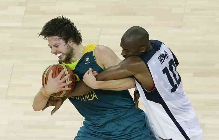 United States' Kobe Bryant, right, and Australia's Matt Dellavedova, left, scramble for the ball during a quarterfinal men's basketball game at the 2012 Summer Olympics, Wednesday, Aug. 8, 2012, in London. (AP Photo/Victor R. Caivano)