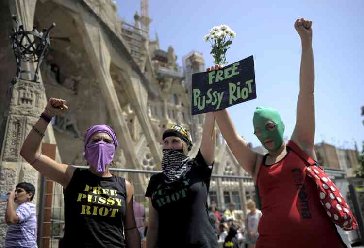 Supporters of all-girl punk band "Pussy Riot" protest near the Sagrada Familia in Barcelona on August 17, 2012 .  A Moscow court on Friday pronounced a guilty verdict in the case of three members of the feminist punk band Pussy Riot who staged a protest against Russian President Vladimir Putin in a landmark church.AFP PHOTO / JOSEP LAGO