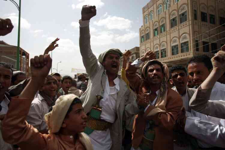 Yemeni protesters shout slogans during a demonstration on a road leading to the US embassy in Sanaa on September 21, 2012 to protest against a US-made film mocking Islam as security forces prevented them from reaching Washington's heavily guarded embassy. The protesters demanded "the departure of the US ambassador and foreign forces in Yemen," in reference to 50 Marines who were dispatched last week to protect the embassy. AFP PHOTO/MOHAMMED HUWAIS