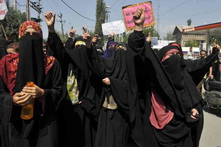 Activists of Kashmir's right wing all-woman organisation Dukhtaran-E-Milat (Daughters of the Faith) shout anti-US slogans  during a protest in Srinagar on September 21, 2012, against the "Innocence of Muslims" film, which has triggered angry demonstrations around the world.   Police fired teargas shells to disperse protestors and detained activists as they took part in a protest against the crudely made film, produced by US-based extremist Christians, which has triggered protests in at least 20 countries since excerpts were posted online.    AFP PHOTO/Tauseef MUSTAFA