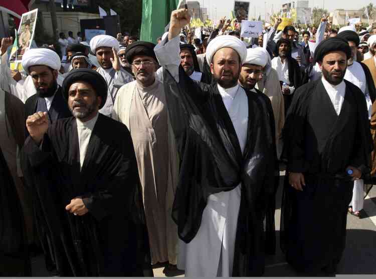 Iraqis chant slogans during a protest in Basra, 340 miles (547 kilometers) southeast of Baghdad, Iraq, Friday, Sept. 21, 2012, as part of widespread anger across the Muslim world about a film ridiculing Islam's Prophet Muhammad. (AP Photo/Nabil al-Jurani)