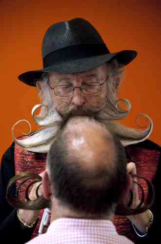 Competitors get prepared prior to go on stage during the first edition of the European Beard and Moustache championships on September 22, 2012 in Wittersdorf, eastern France.  AFP PHOTO / SEBASTIEN BOZON