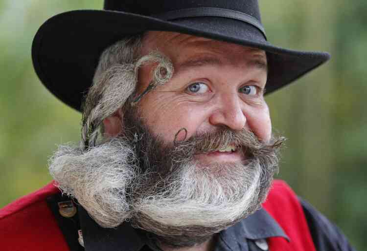 German hairdresser Elmar Weisser, 48, poses with his beard, which is shaped as a stork, during the 2012 European Beard and Moustache Championships in Wittersdorf near Mulhouse, Eastern France, September 22, 2012. Weisser, who won the World Beard and Moustache Championship in 2011, ranked second in the freestyle category of the European championships on Saturday. Picture taken September 22, 2012. REUTERS/Vincent Kessler (FRANCE - Tags: SOCIETY TPX IMAGES OF THE DAY)