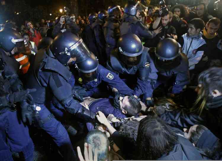 Police clash with protestors during a demonstration at the parliament against austerity measures announced by the Spanish government in Madrid, Spain, Wednesday, Sept. 26, 2012. Spain's Parliament has taken on the appearance of a heavily guarded fortress with dozens of police blocking access from every possible angle, hours ahead of a protest against the conservative government's handling of the economic crisis. (AP Photo/Andres Kudacki)