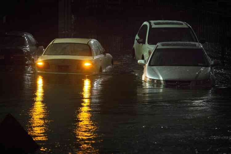 Vehicles are submerged during a storm surge near the Brooklyn Battery Tunnel, Monday, Oct. 29, 2012, in New York. Superstorm Sandy zeroed in on New York's waterfront with fierce rain and winds that shuttered most of the nation's largest city Monday, darkened the financial district and left a huge crane hanging off a luxury high-rise. (AP Photo/John Minchillo)