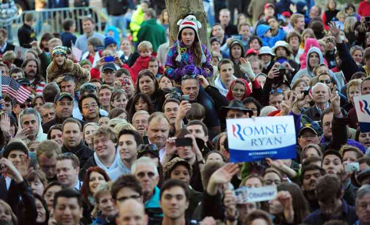 Supporters of US Republican presidential candidate Mitt Romney await his arrival in an overflow area during a rally at George Mason University in Fairfax, Virginia, November 5, 2012. After a grueling 18-month battle, the final US campaign day arrived for President Barack Obama and Republican rival Mitt Romney, two men on a collision course for the world's top job. The candidates have attended hundreds of rallies, fundraisers and town halls, spent literally billions on attack ads, ground games, and get out the vote efforts, and squared off in three intense debates. AFP PHOTO/Emmanuel DUNAND