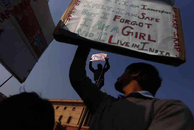 Protesters hold up banners near the Presidential Palace in New Delhi, India, Saturday, Dec. 22, 2012. Police used tear gas and water cannons to push back thousands of people who tried to march to the presidential mansion to protest the recent gang rape and brutal beating of a 23-year-old student on a moving bus. (AP Photo/Saurabh Das)