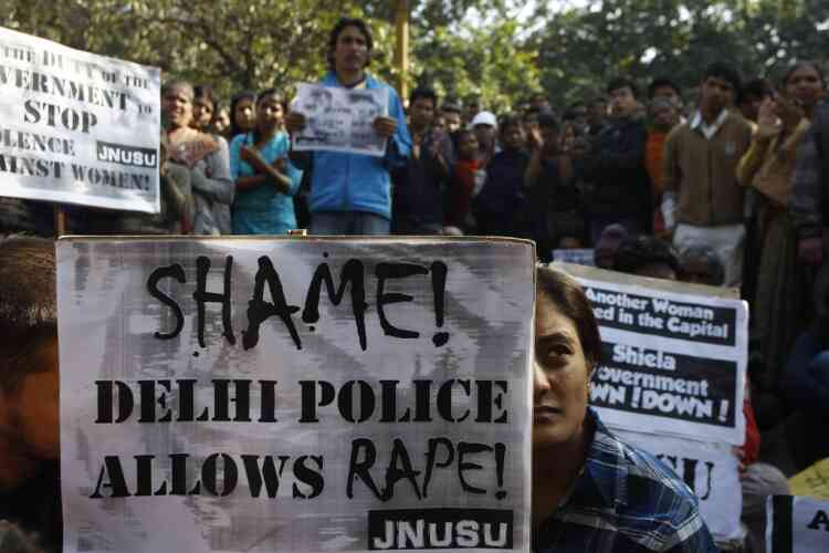 An Indian woman along with the others participates in a protest condemning the gang rape of a 23-year-old student on a city bus late Sunday in New Delhi, India, Tuesday, Dec. 18, 2012. The Indian parliament Tuesday witnessed outrage over the issue even as the victim is battling for her life at a city hospital. (AP Photo/Tsering Topgyal)