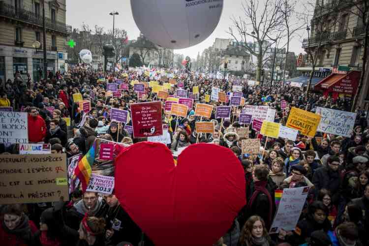 People demonstrate in support of a government project to legalize same-sex marriage and adoption for same-sex couples in Paris, France, Sunday, Jan. 27, 2013. (AP Photo/Benjamin Girette)