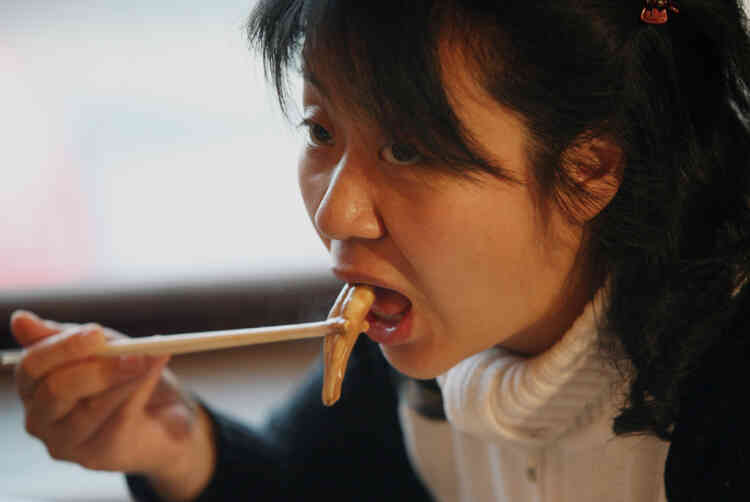 A Chinese woman eats from an ox and dog penis dish at the Guolizhuang "strength in the pot" penis restaurant in China's capital Beijing March 3, 2006. The restaurant offers more than 30 types of animal penises served in a Chinese hotpot style. According to the theory of traditional Chinese medicine, the penis of certain animals is full of nutrients which brings men energy. And because it contains gelatine albumen, it is said to have excellent cosmetic effects for women, especially beneficial for the skin. REUTERS/Reinhard Krause - RTR16TES