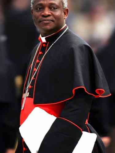 Cardinal Turkson of Ghana arrives to attend mass led by bishop Sandri of Argentina in St Peter's Basilica at Vatican.  Cardinal Peter Kodwo Appiah Turkson of Ghana arrives to attend a mass led by bishop Leonardo Sandri of Argentina in St. Peter's Basilica at the Vatican April 13, 2005. Conservative Cardinal Joseph Ratzinger has gained strong support among Roman Catholic cardinals seeking a successor to Pope John Paul but many of them are still undecided, a Church official said on Wednesday. REUTERS/Max Rossi - RTR80ZT