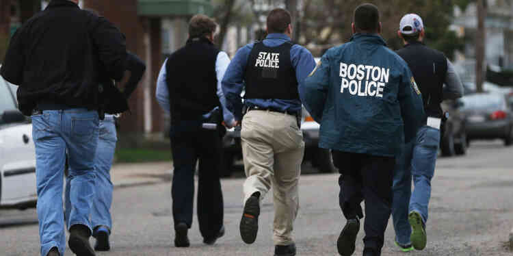 WATERTOWN, MA - APRIL 19: Police officers run towards a home they believed 19-year-old bombing suspect Dzhokhar A. Tsarnaev may be hiding on April 19, 2013 in Watertown, Massachusetts. After a car chase and shoot out with police, one suspect in the Boston Marathon bombing, Tamerlan Tsarnaev, 26, was shot and killed by police early morning April 19, and a manhunt is underway for his brother and second suspect, 19-year-old suspect Dzhokhar A. Tsarnaev. The two men, reportedly Chechen origin, are suspects in the bombings at the Boston Marathon on April 15, that killed three people and wounded at least 170.   Mario Tama/Getty Images/AFP== FOR NEWSPAPERS, INTERNET, TELCOS & TELEVISION USE ONLY ==