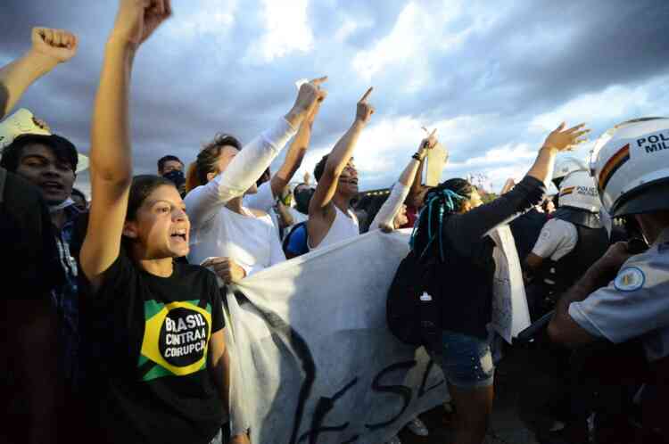 Students shout slognas after taking the National Congress during a protest, on June 17, 2013 in Brasilia. Tens of thousands of people took to the streets of major Brazilian cities protesting the billions of dollars spent on the Confederations Cup --and preparations for the upcoming World Cup-- and against the hike in mass transit fares.  AFP PHOTO / Evaristo SA