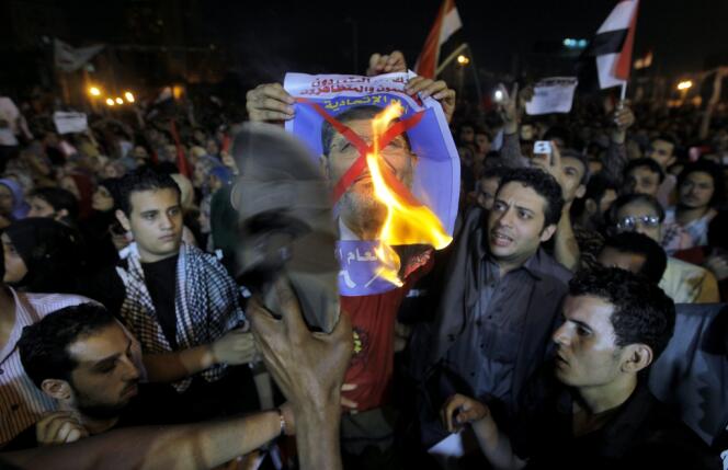 Des manifestants égyptiens brûlent le portrait du président Mohammed Morsi place Tahrir, au Caire, le 26 juin 2013.