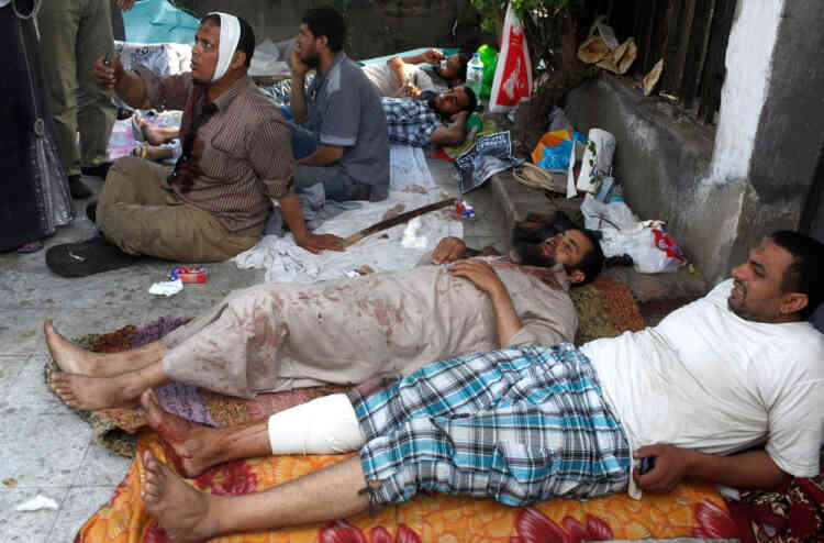 Wounded supporters of deposed Egyptian president Mohamed Mursi wait for treatment at a field hospital in Cairo, July 8, 2013. The death toll in violence on Monday at the Cairo headquarters of the Republican Guard rose to 42, Egyptian state television said, after the Muslim Brotherhood accused the security forces of attacking protesters there. REUTERS/Asmaa Waguih (EGYPT - Tags: POLITICS CIVIL UNREST)