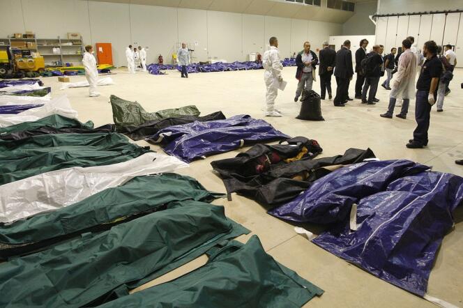 Des corps de migrants alignés dans un hangar de l'aéroport de Lampedusa, le 3 octobre 2013.