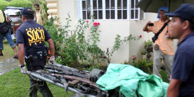 Des policiers philippins transportent des armes saisies sur des combattants du CPP, en juillet 2013, dans la province Tarlac, au nord de Manille.
