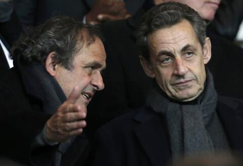 UEFA President Michel Platini (L) and former French president Nicolas Sarkozy speak ahead of the Champions League round of 16 first leg soccer match where Paris St Germain faces Chelsea at the Parc des Princes Stadium in Paris February 17, 2015. REUTERS/Christian Hartmann (FRANCE - Tags: SPORT SOCCER POLITICS)