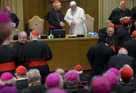 Pope Francis talks with Cardinal Lorenzo Baldisseri, before the start of the morning session of the Synod of bishops, at the Vatican, Friday, Oct. 9, 2015. (AP Photo/Alessandra Tarantino)