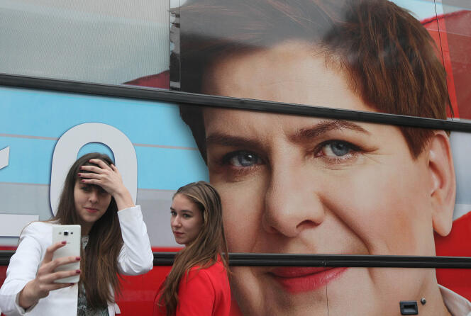 A Varsovie, un selfie devant une affiche pour Beata Szydlo, la chef de campagne du parti conservateur, le mieux placé dans les sondages pour les législatives polonaises.(AP Photo/Czarek Sokolowski)