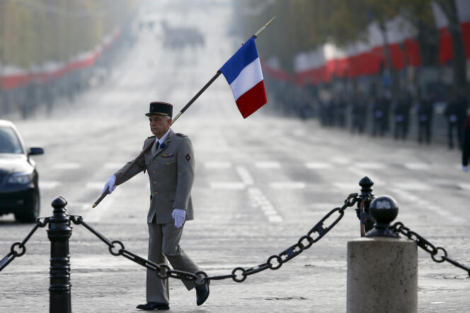 Un militaire portant un drapeau lors des cérémonies du 11-Novembre à l’arc de Triomphe, à Paris en 2015.