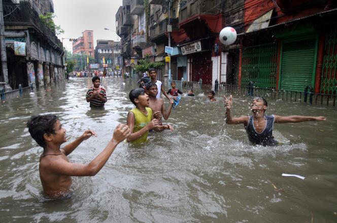 La croyance qui accable le Nord repose sur des données tronquées, qui ne retiennent que les émissions de dioxyde de carbone (CO2) d’origine énergétique (charbon, pétrole, gaz) (Photo: enfants jouant dans une rue de Calcutta en proie aux inondations dues aux pluies saisonnières de la mousson).