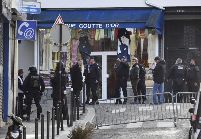 French criminal police are seen in the Rue de la Goutte d'Or in the north of Paris on January 7, 2016, after police shot a man dead as he was trying to enter a police station