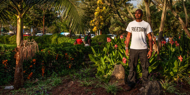 Kenyan activist Boniface Mwangi stands for a portrait in Uhuru Park in Nairobi, Kenya. (Pete Muller/PRIME for Le Monde)
