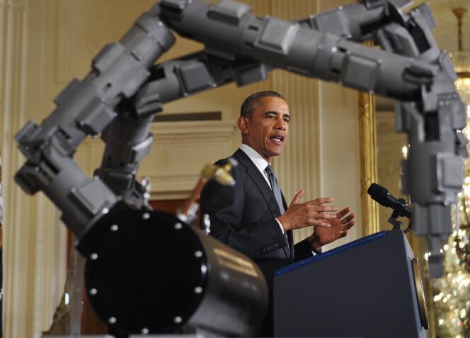 Le Président des Etats-Unis à une conférence de presse à la Maison Blanche, en février 2014, sur l'utilisation d'engins robotisés dans l'armée américaine. Au premier plan, des bras robotisés destinés à désamorcer des explosifs sous l'eau.