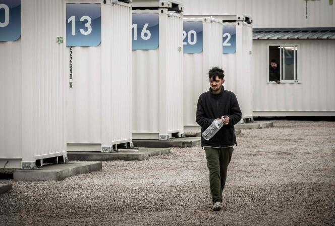 Un homme chemine dans le nouveau camp de conteneurs de Calais.