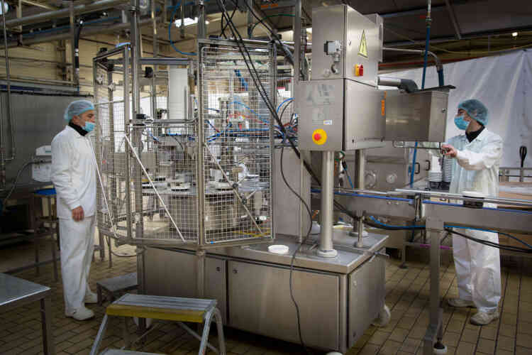Stéphane Alaux et Jérôme Sanso contrôlent le fonctionnement de la "ruff", la machine qui permet la mise en pot automatique de la crème glacée.