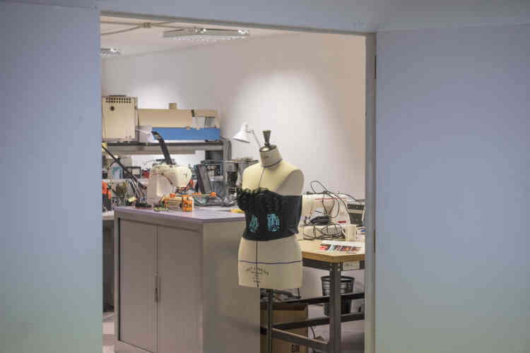 Dans l'atelier couture, une créatrice fabrique des vêtements ornée de motifs électroniques à diodes.