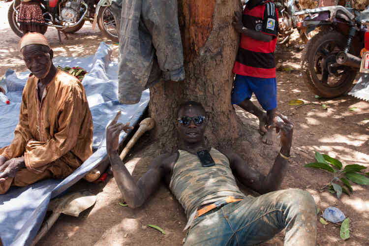 Après une dure matinée, les orpailleurs prennent un peu de repos à l’ombre des nombreux arbres de la mine de Gbekeno