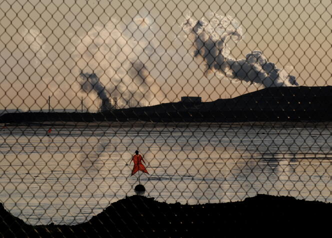 A scarecrow lies in a tailings pond in front of the Suncor oil sands extraction facility near the town of Fort McMurray in Alberta Province, Canada on October 25, 2009.
