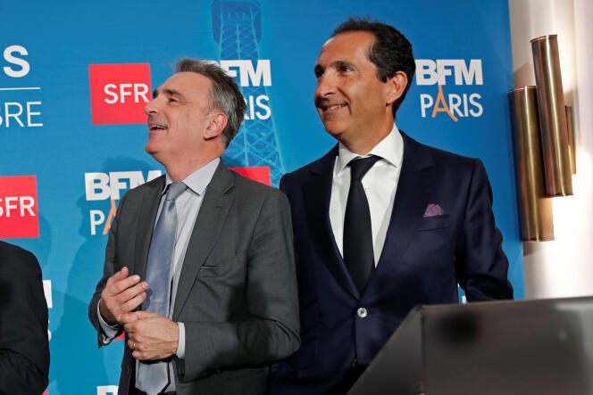 Michel Paulin (gauche), alors PDG de SFR Telecom et Patrick Drahi (droite), PDG d’Altice, au lancement de la chaîne de télévision BFM-TV en novembre 2016.
