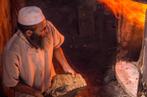 Jessica Bordeau/GERES Un « farnatchi » alimente une chaudière traditionnelle dans un hammam.