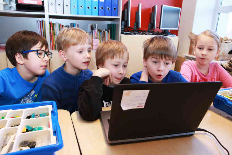 Cours de robotique. Les élèves s’appuient sur un schéma à l’écran pour  assembler des connections. Au début des années 2000, les primaires apprenaient les rudiments du code informatique. Désormais, les professeurs leur enseignent également comment programmer des robots.