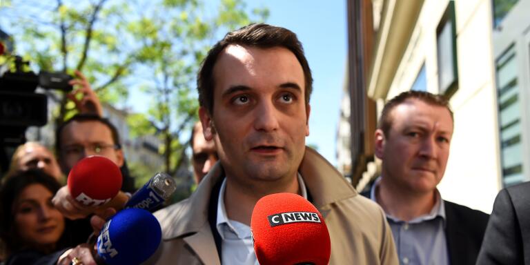 French far-right Front National (FN) party Vice-President Florian Philippot answers journalists' questions outside the 