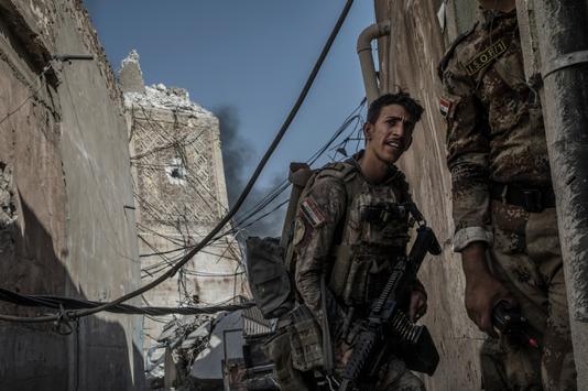 Un soldat passe à hauteur du socle du minaret Al-Hadba détruit par les membres du groupe Etat Islamique, le 29 juin.